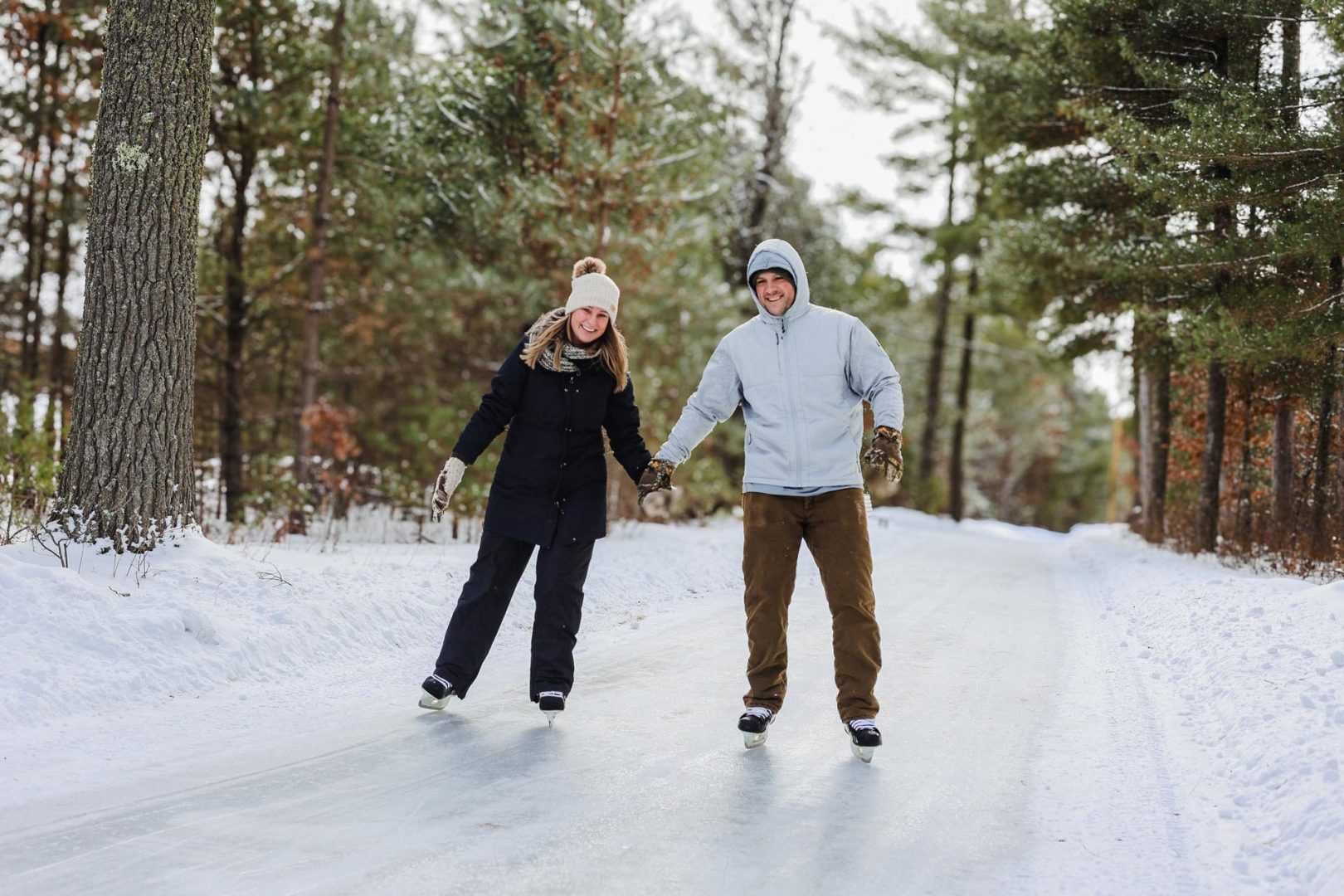 A couple ice skating The Glide ice skating rail at Winter Park