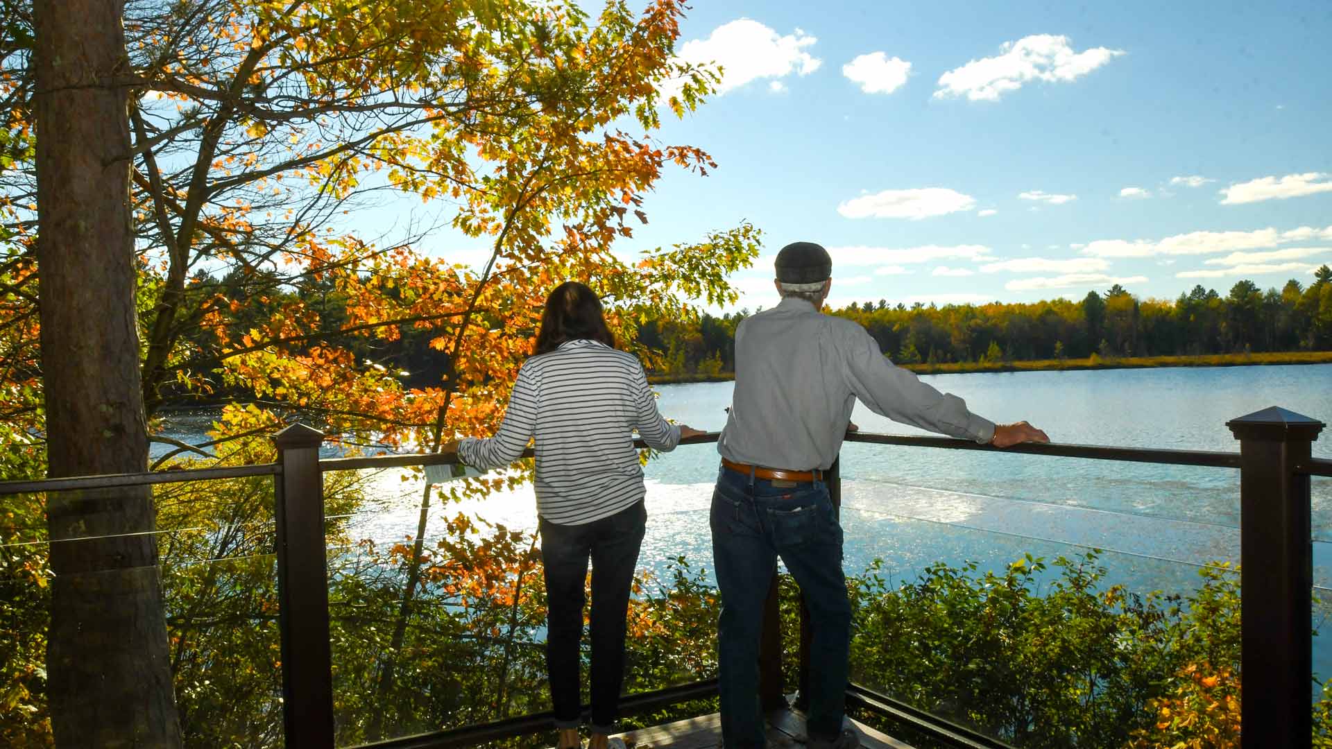 Couple admiring a fall lake on North Lakeland Discovery Center Trails in Vilas County, Wisconsin