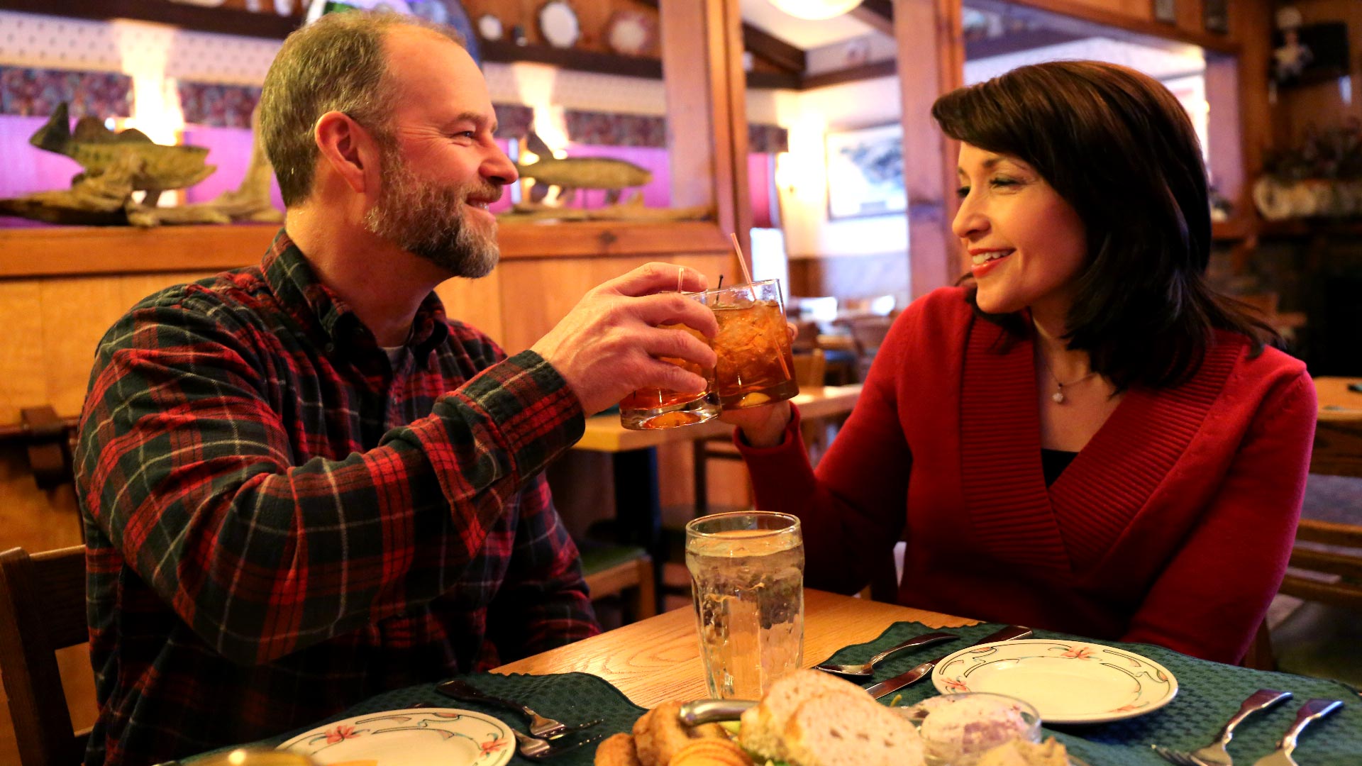 Couple enjoys after dinner drinks in rustic restaurant interior