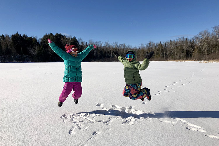 Children on a snow-covered lake Presque Isle Wisconsin