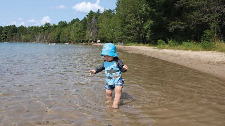 Child playing in the water at Crystal Lake Campground