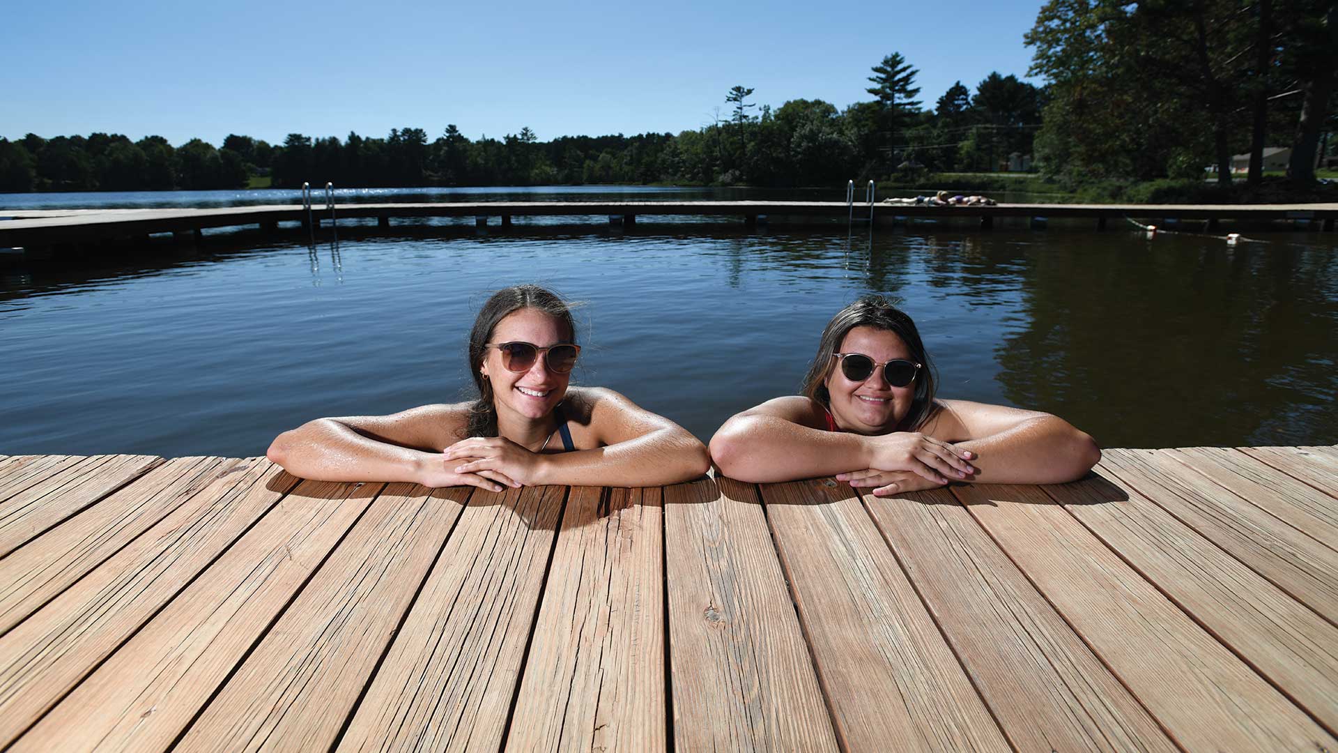 Girls resting on the dock after swimming at City Beach