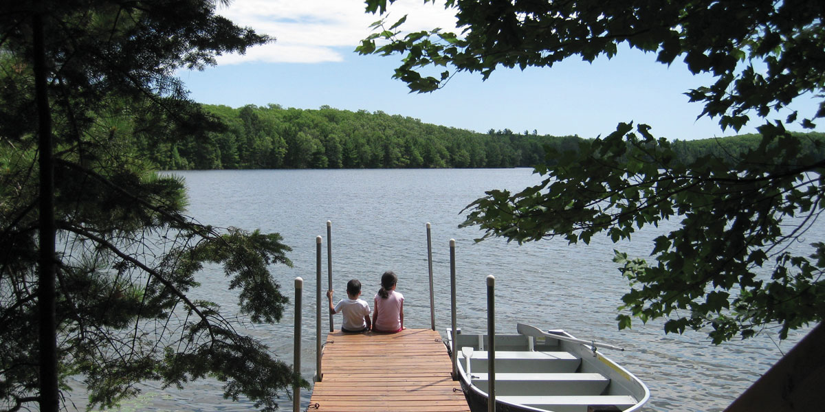 Kids sitting on dock in Sayner/Star Lake, Wisconsin