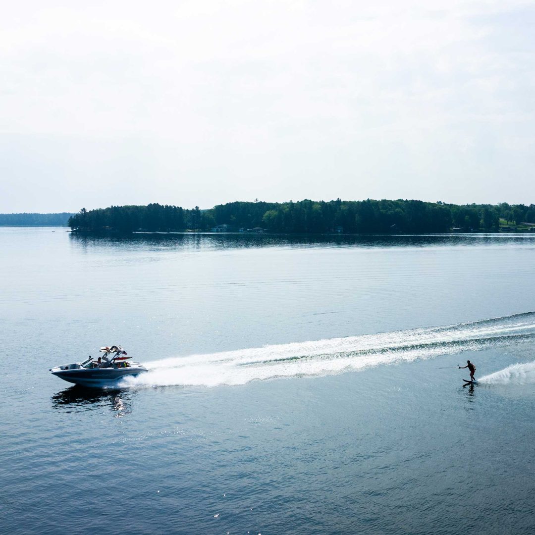 Motor boat pulling a skier on a lake in Minocqua