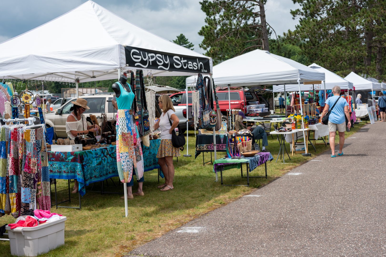 Craft show vendors with people shopping