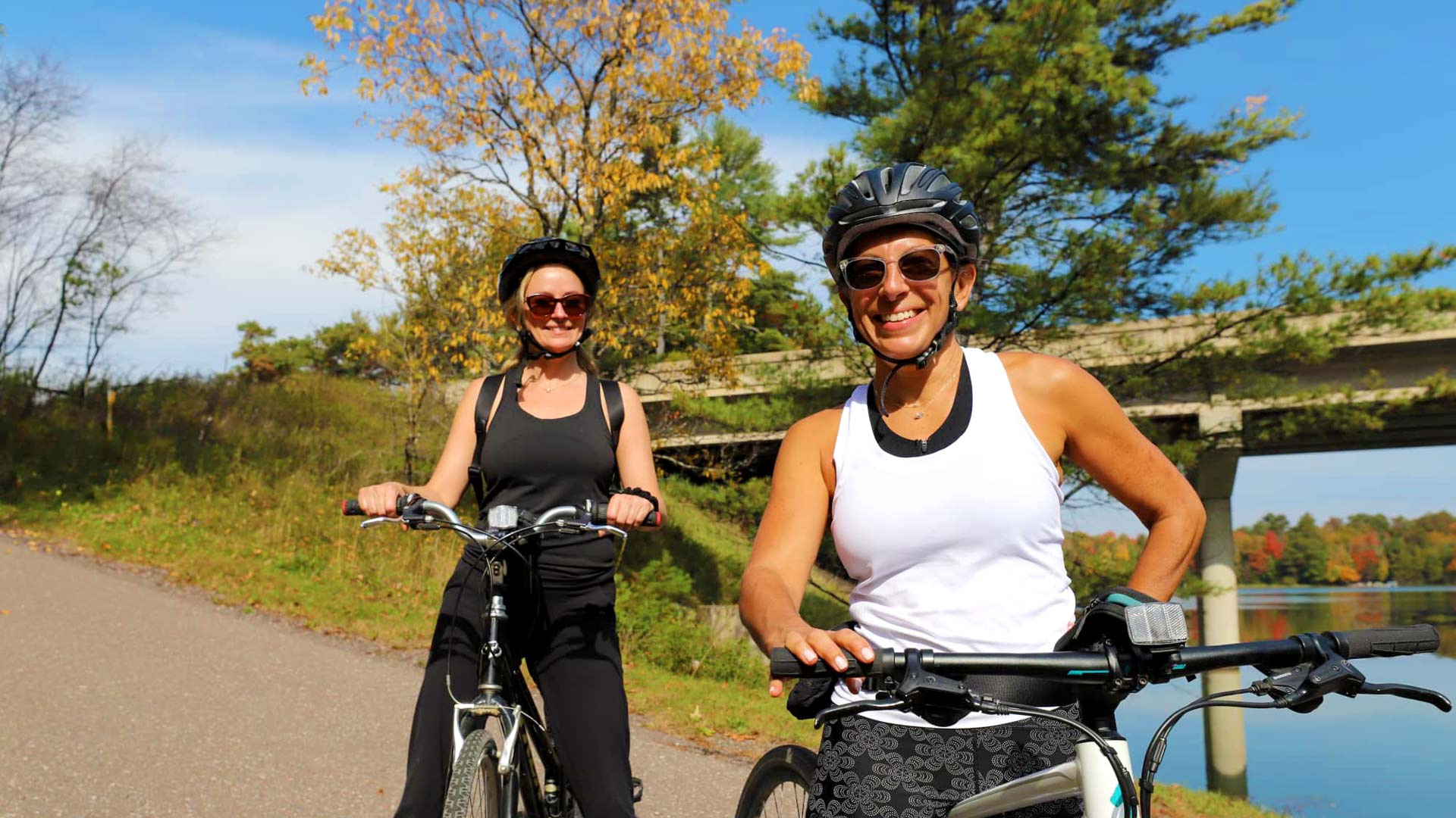 Two women biking on the Heart of Vilas County Trail in St. Germain WI