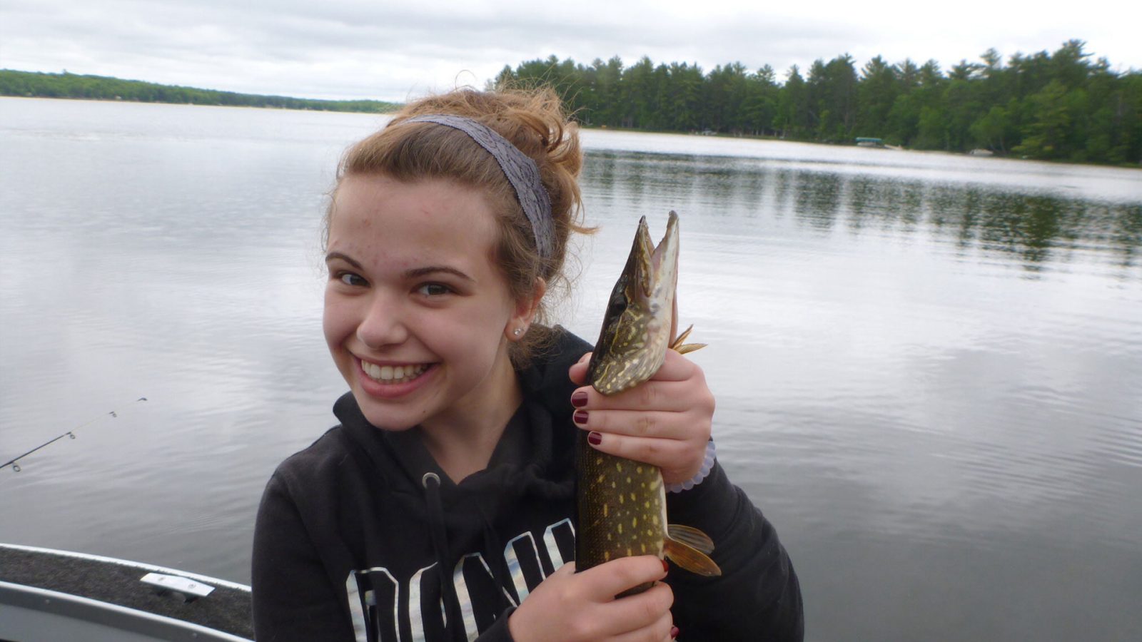 Girl with northern pike on lake in Vilas County Wisconsin