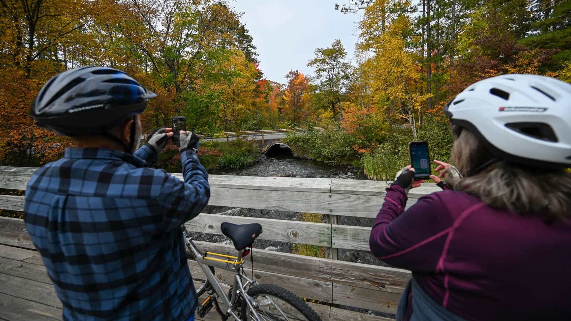 Couple photographing fall color on Heart of Vilas County Bike Trail in Boulder Junction WI