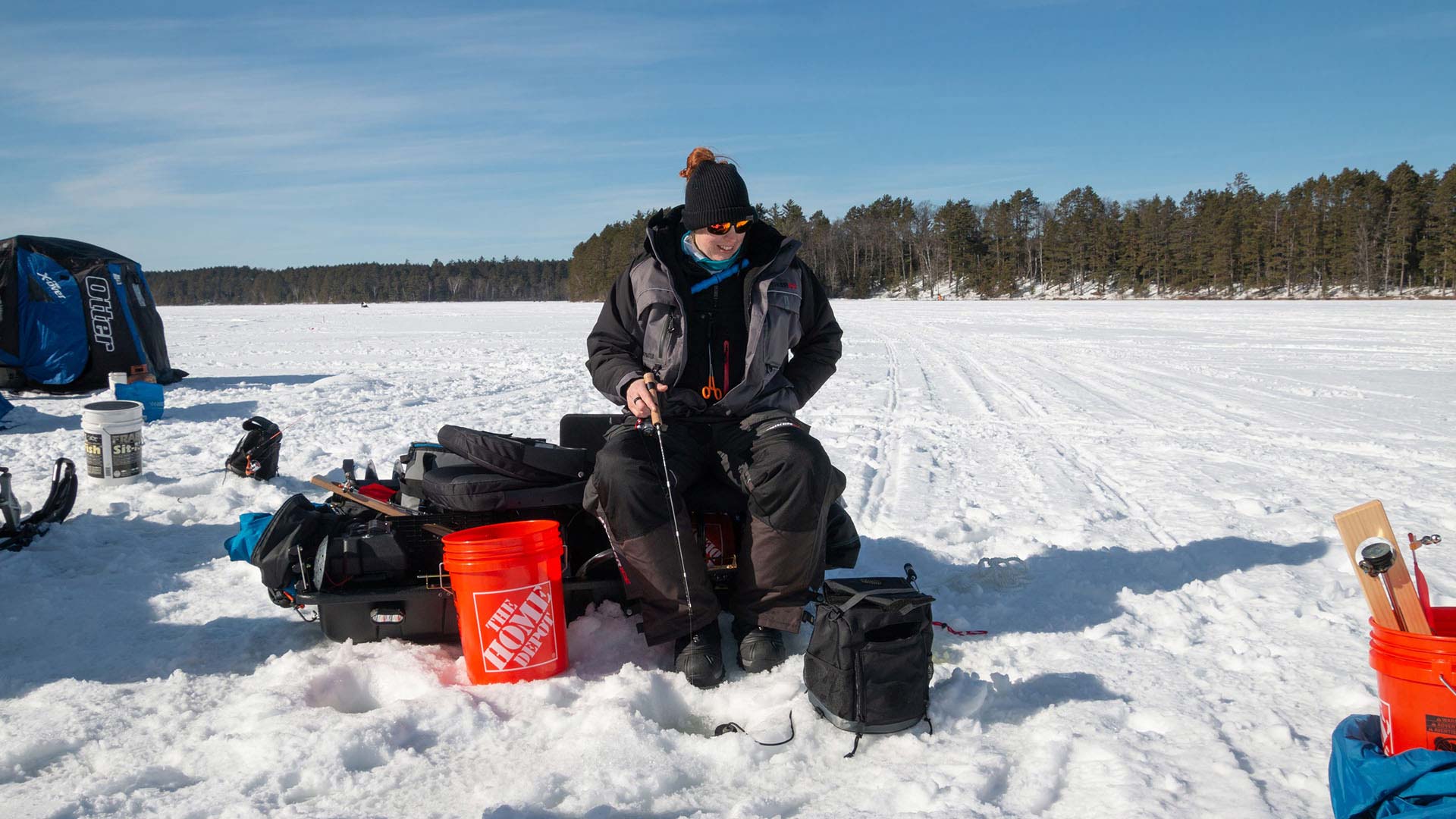 Ice fisher waiting for a bit on Plum Lake