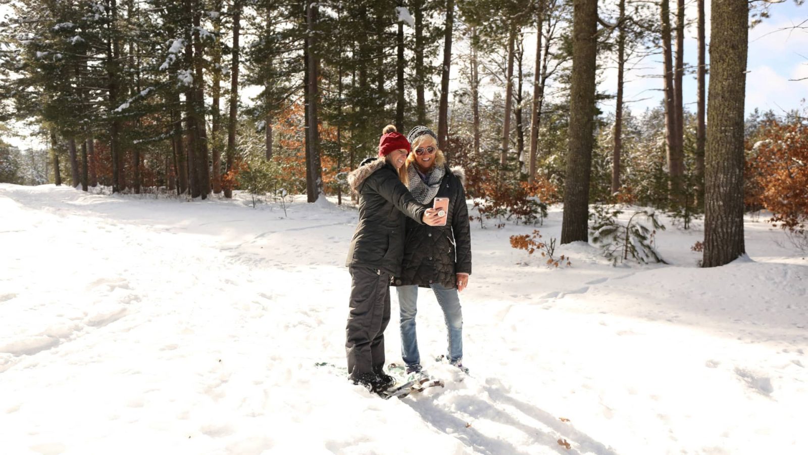 Two women taking a selfie while snowshoeing at Boulder Junction Winter Park in Vilas County WI