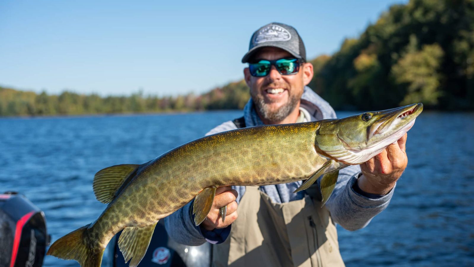 Man showing off musky he caught on Crab Lake in Presque Isle in Vilas County Wisconsin