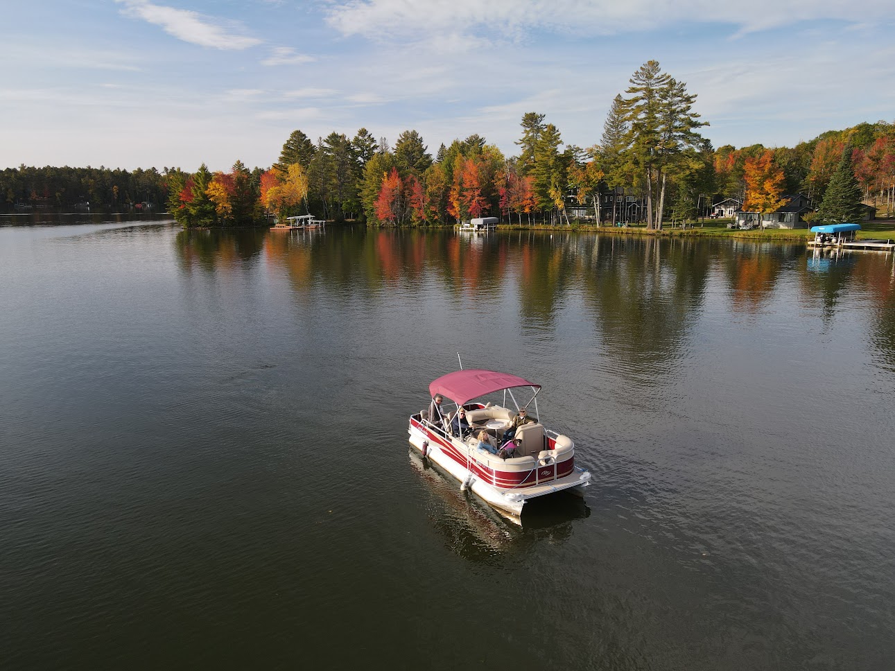 A pontoon on Otter Lake during fall