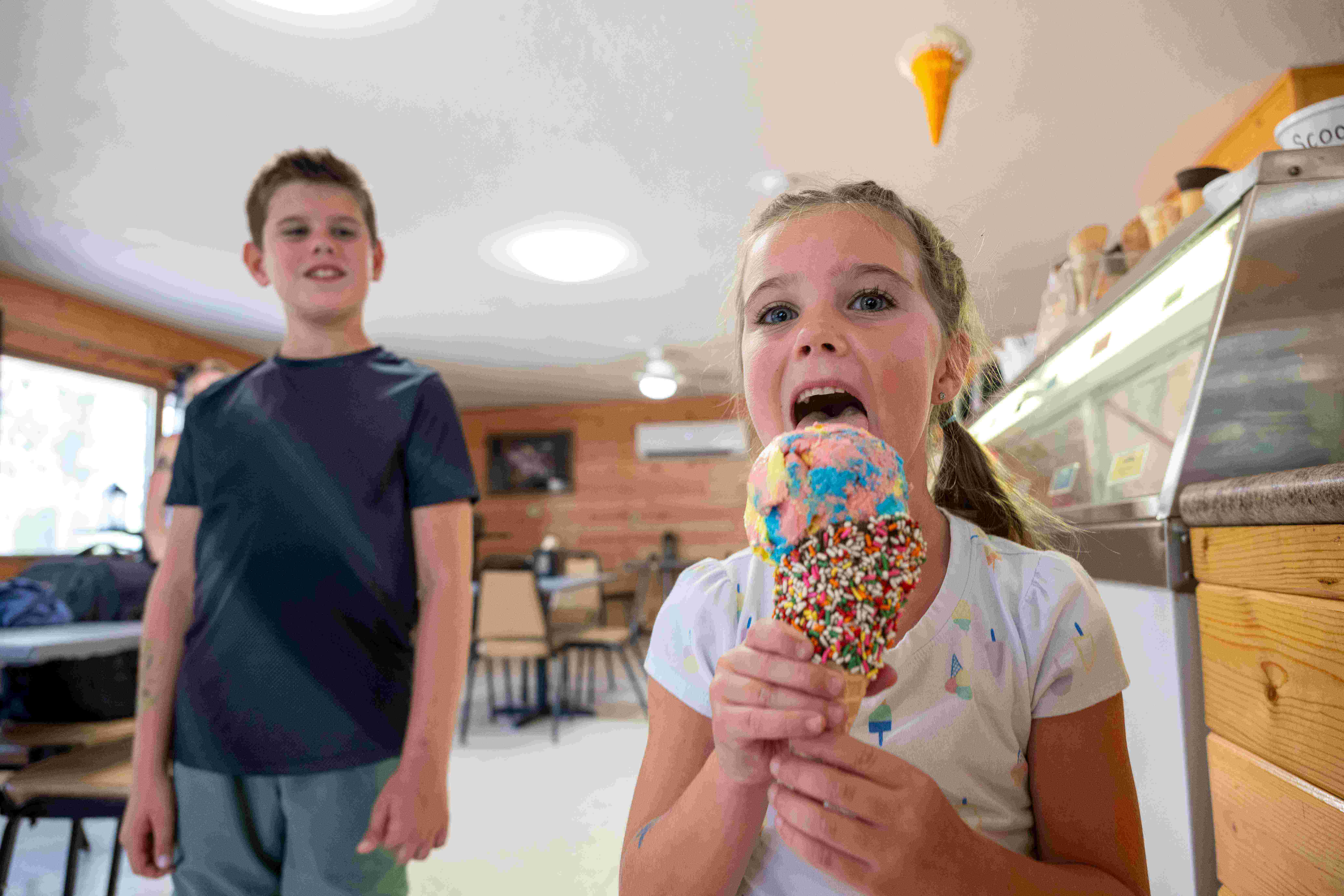 Two children enjoying an ice cream cone inside Elmer's Fun Park in St. Germain