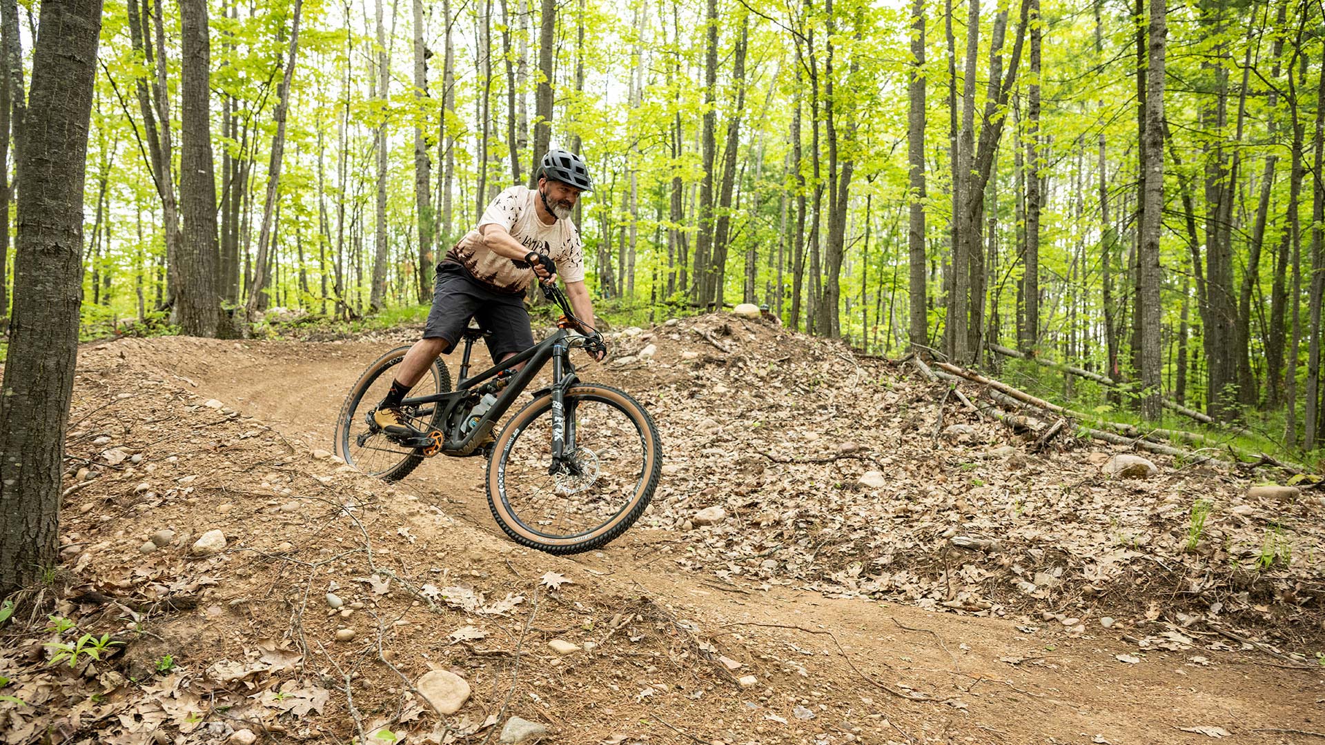 Man biking down the Muksy Mountain Bike Trail